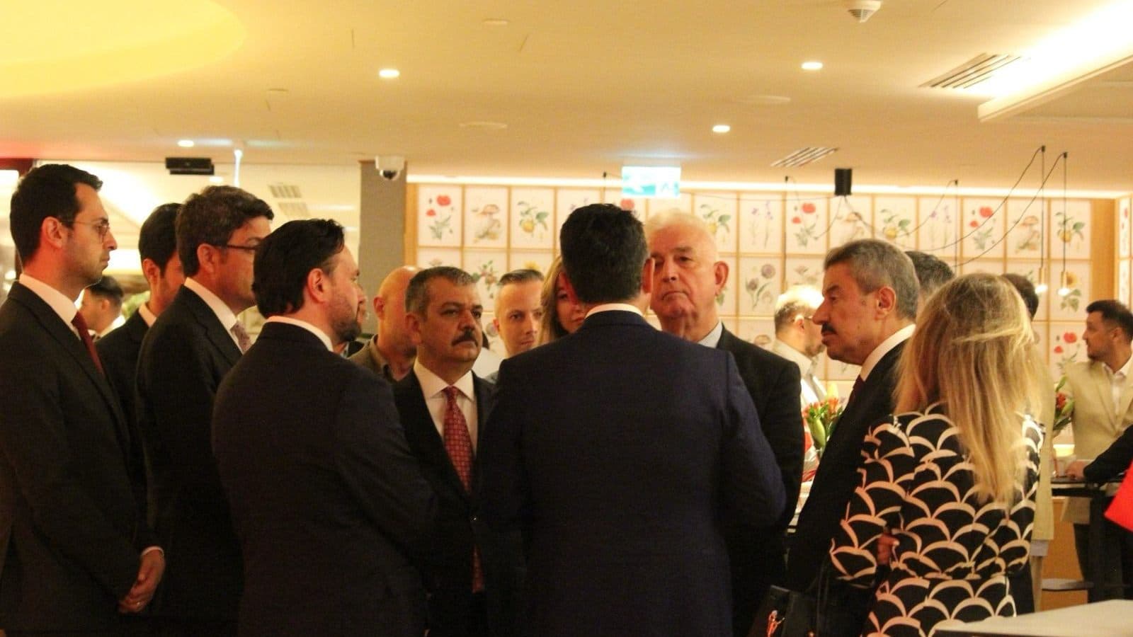 Guests in small groups in conversation at the Warsaw reception